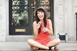 lifestyle model blowing bubbles sitting on steps