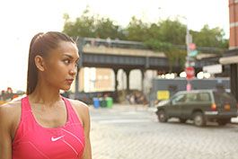 lifestyle model looking across street at highline tracks